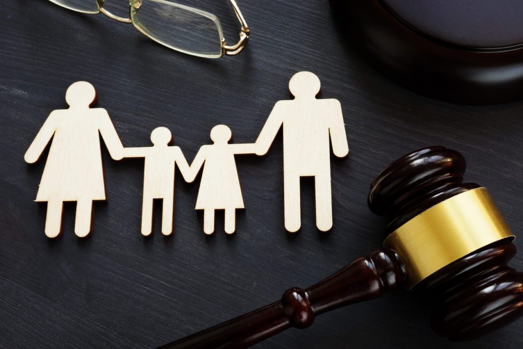 cutout of a family next to gavel